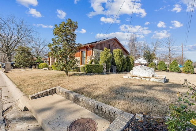 view of side of home with a yard