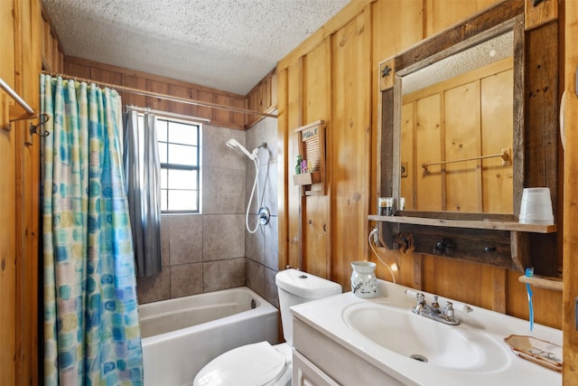 full bathroom with a textured ceiling, vanity, shower / bathtub combination with curtain, toilet, and wood walls