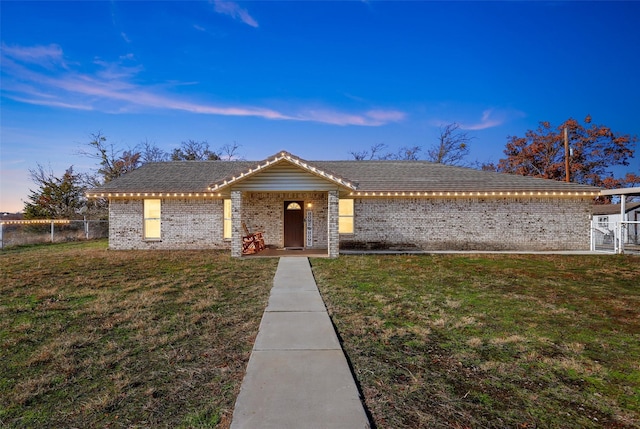 ranch-style house featuring a lawn