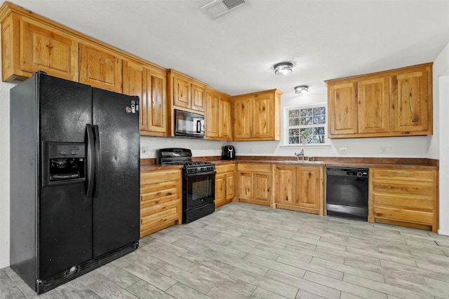 kitchen featuring sink and black appliances