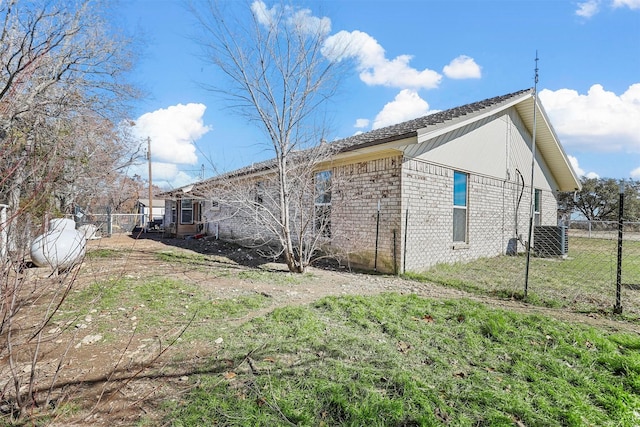 view of side of home with a lawn