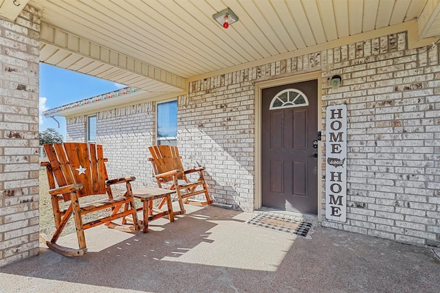 view of exterior entry with covered porch