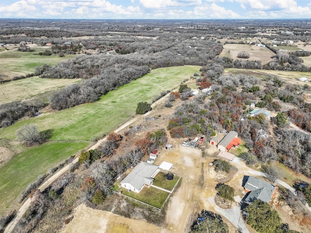 birds eye view of property with a rural view