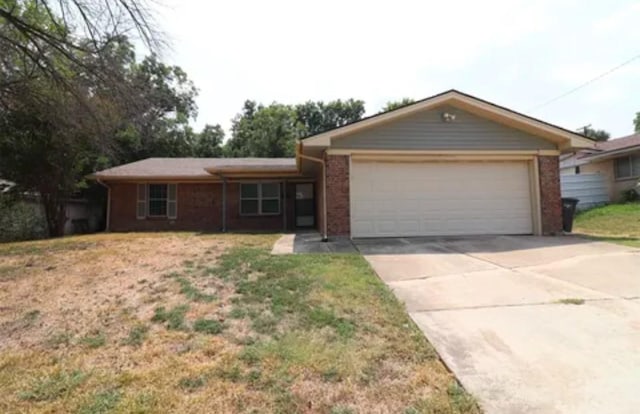 single story home with a front yard and a garage