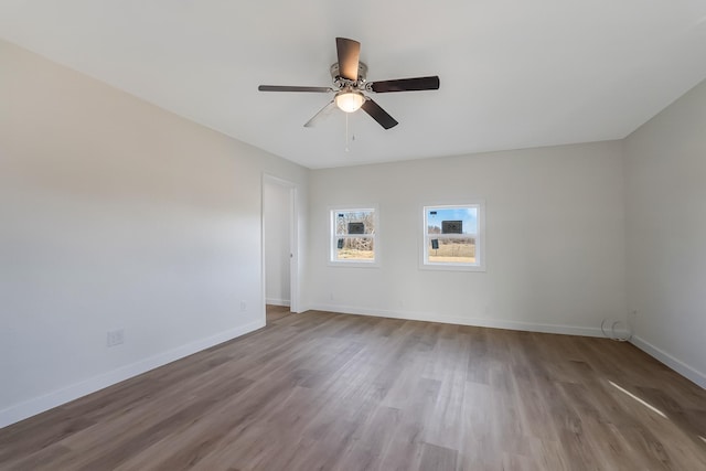 unfurnished room featuring hardwood / wood-style flooring and ceiling fan