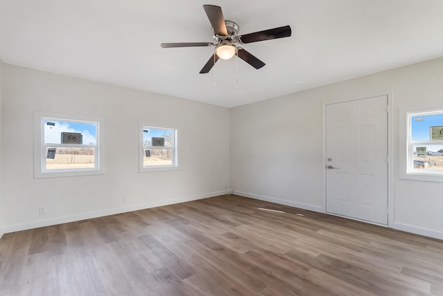 empty room featuring ceiling fan and light wood-type flooring