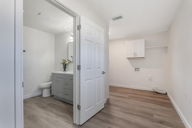 washroom with washer hookup and light wood-type flooring