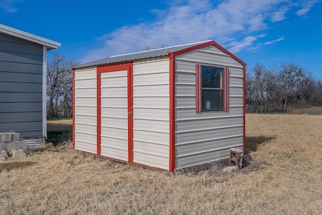 view of outbuilding featuring a yard