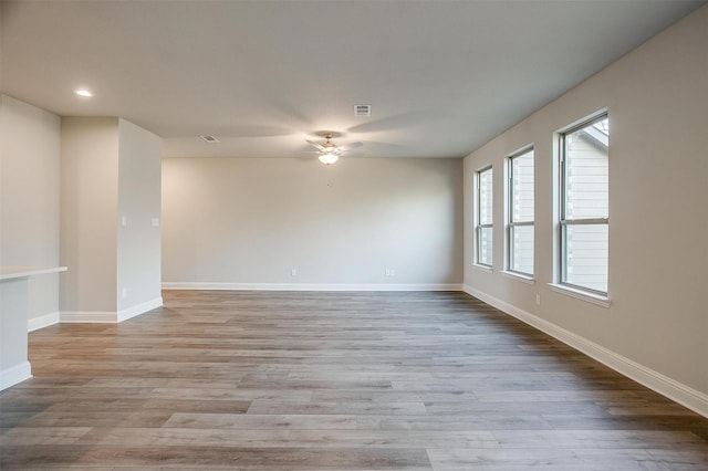 unfurnished room with ceiling fan and light wood-type flooring