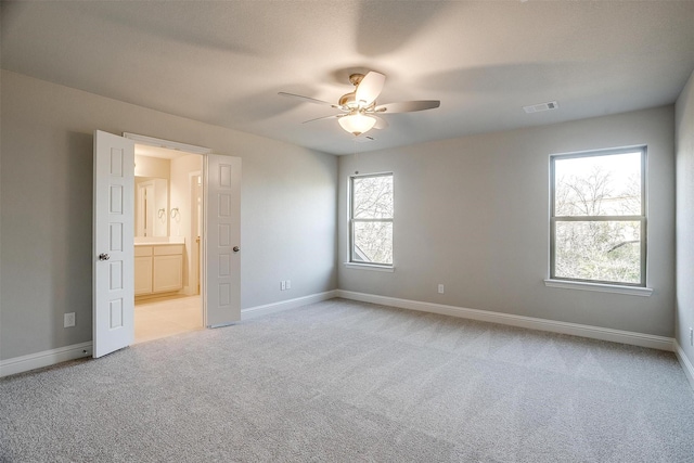 unfurnished room with light carpet and ceiling fan