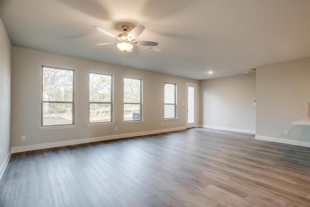 spare room with wood-type flooring and ceiling fan