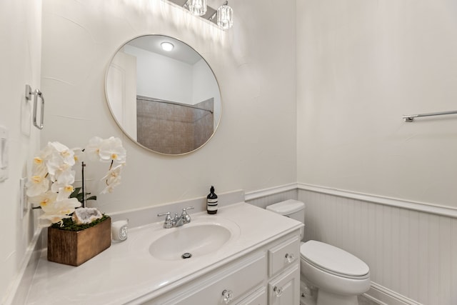 bathroom featuring a shower, vanity, and toilet