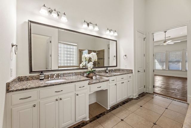 bathroom featuring tile patterned flooring, vanity, and ceiling fan