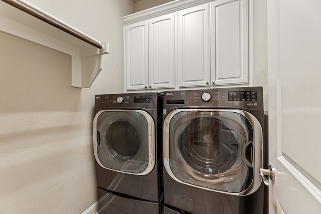 washroom featuring washer and clothes dryer, tile patterned flooring, and cabinets