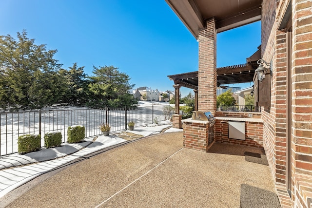 view of patio / terrace with area for grilling and a pergola