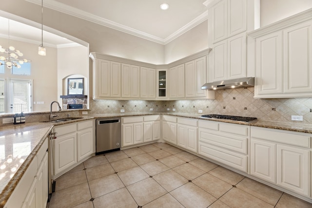 kitchen featuring sink, light stone countertops, tasteful backsplash, light tile patterned flooring, and stainless steel appliances