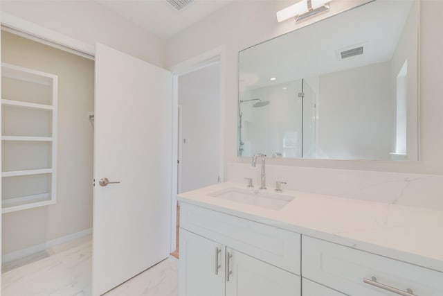 bathroom with vanity and a shower with door