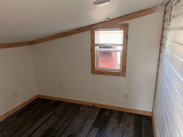 additional living space with a textured ceiling and dark hardwood / wood-style floors