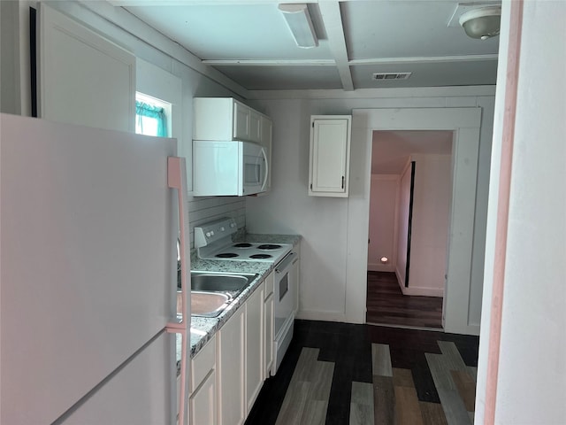 kitchen featuring white appliances, dark hardwood / wood-style floors, and white cabinetry