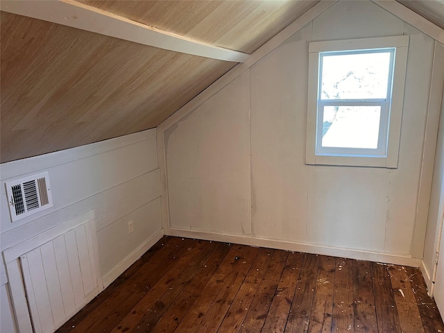 additional living space with dark hardwood / wood-style flooring and vaulted ceiling