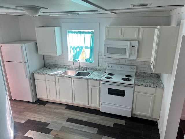 kitchen featuring white appliances, white cabinets, and sink