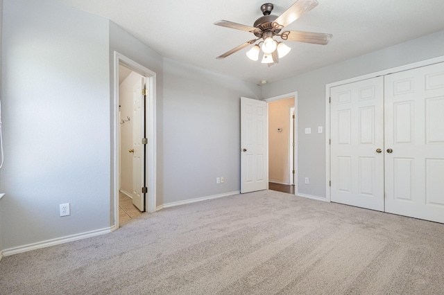 unfurnished bedroom with ceiling fan, light carpet, and a closet