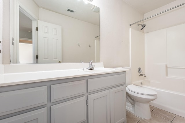 full bathroom featuring toilet, vanity, tile patterned floors, and shower / washtub combination