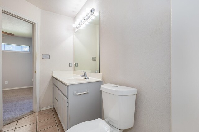 bathroom featuring tile patterned floors, vanity, and toilet