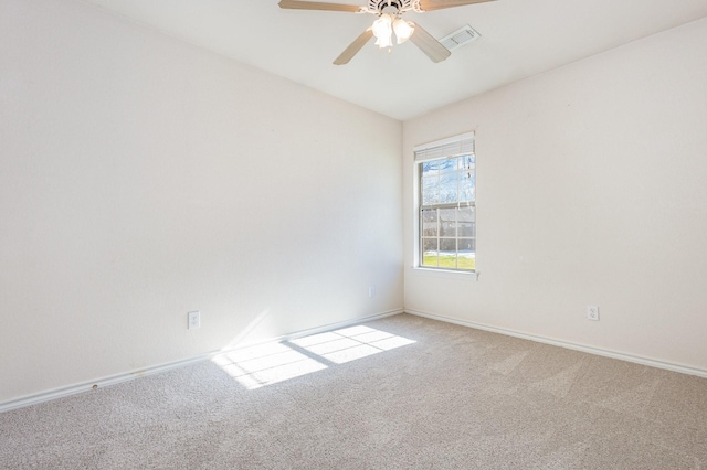 unfurnished room featuring light carpet and ceiling fan