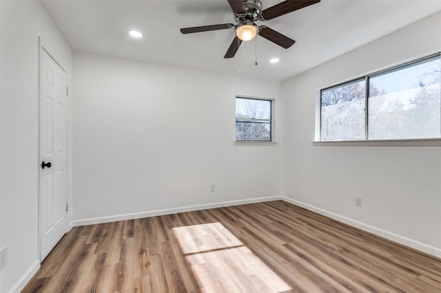 empty room with ceiling fan and wood-type flooring