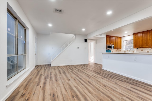 unfurnished living room with light wood-type flooring