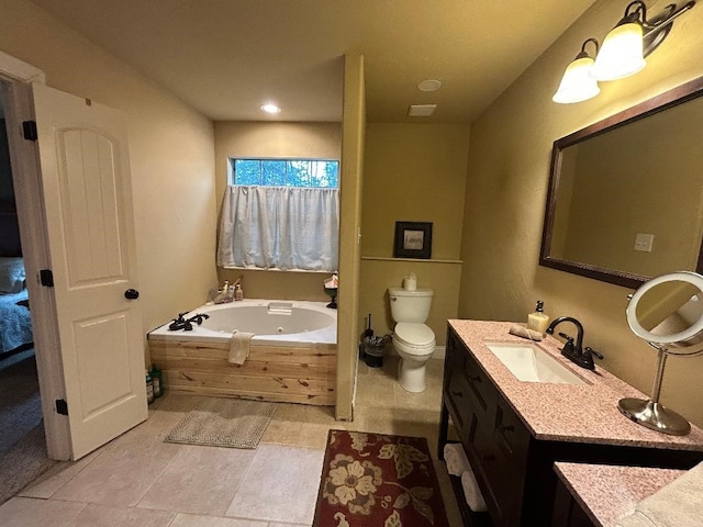 bathroom with vanity, a tub, and toilet