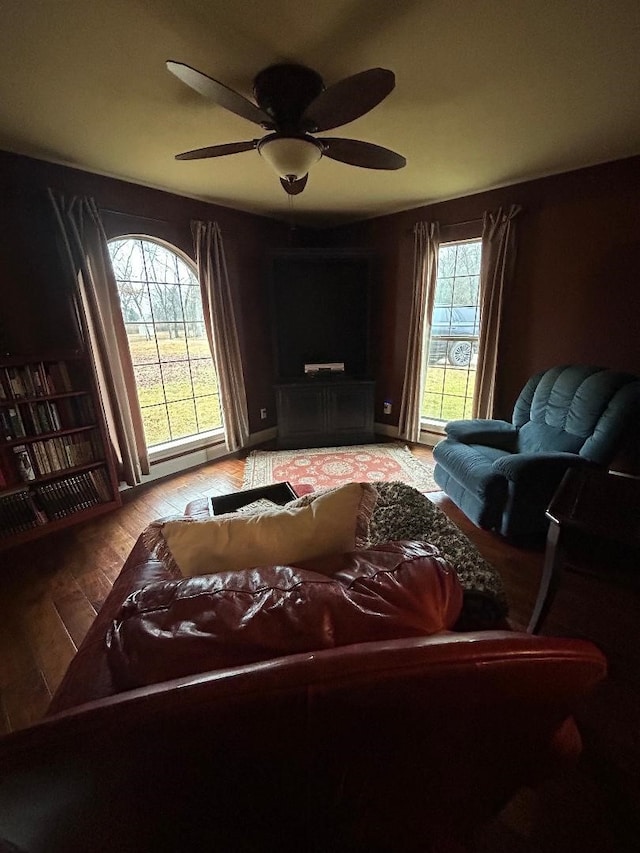 living room featuring a wealth of natural light and ceiling fan