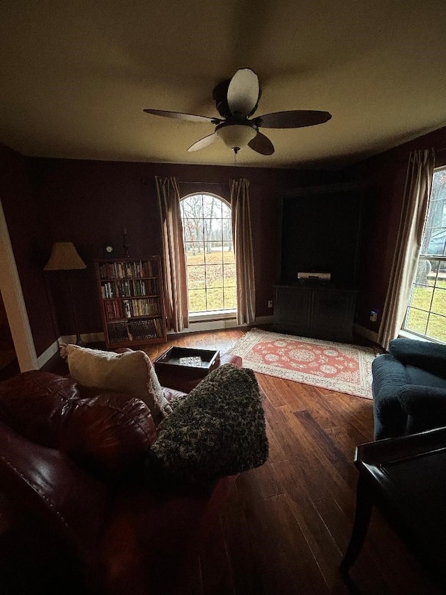 living room with ceiling fan and hardwood / wood-style floors