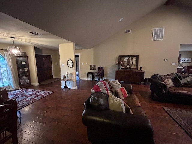 living room featuring dark hardwood / wood-style flooring, vaulted ceiling, and a chandelier