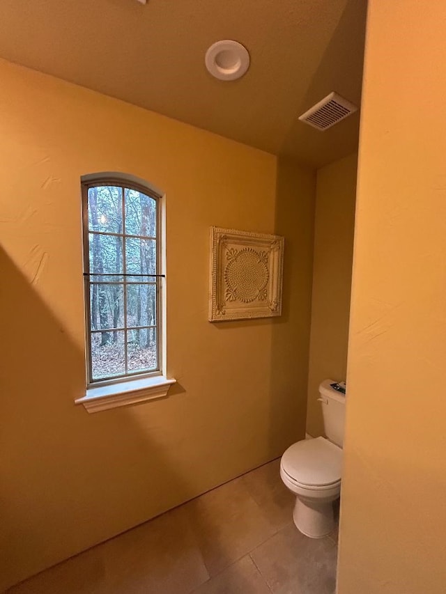 bathroom featuring tile patterned flooring and toilet