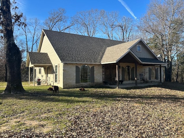 view of front of house with covered porch and a front yard