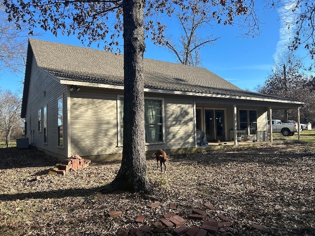 rear view of house with central AC unit and a patio area