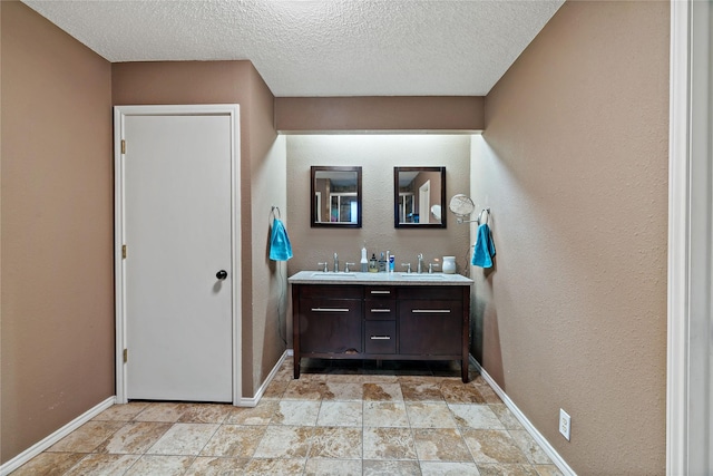 bathroom with vanity and a textured ceiling