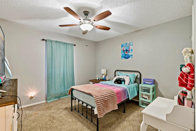 bedroom featuring a textured ceiling, ceiling fan, and light carpet