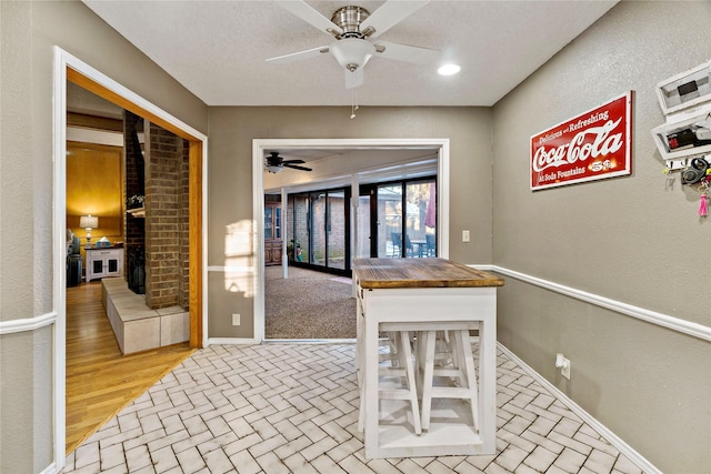 kitchen with butcher block countertops and ceiling fan