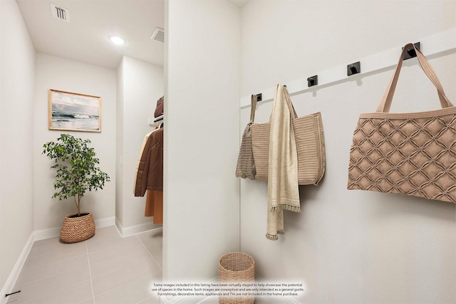 bathroom featuring tile patterned floors, visible vents, and baseboards