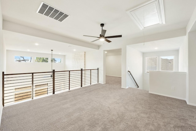 spare room with recessed lighting, carpet flooring, visible vents, baseboards, and attic access