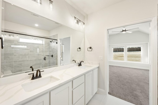 full bath with double vanity, a ceiling fan, a stall shower, and a sink