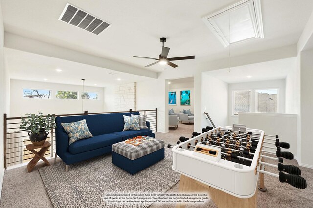 game room featuring a ceiling fan, visible vents, baseboards, attic access, and carpet flooring