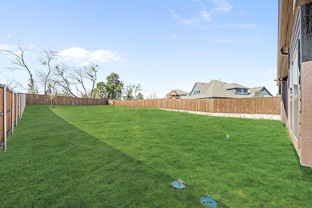 view of yard with a fenced backyard