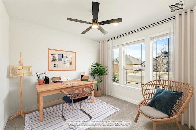 carpeted office space featuring visible vents, baseboards, and a ceiling fan