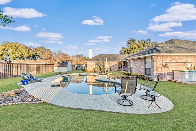 view of swimming pool featuring a storage unit, a patio, and a yard