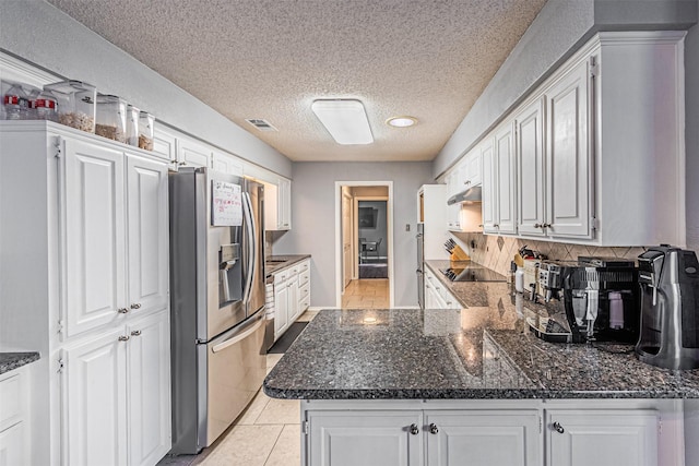 kitchen featuring stainless steel fridge with ice dispenser, kitchen peninsula, light tile patterned flooring, a textured ceiling, and white cabinets