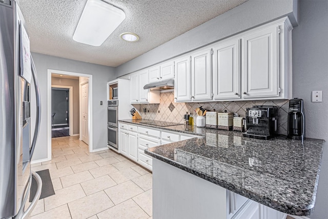 kitchen with kitchen peninsula, white cabinetry, stainless steel appliances, and tasteful backsplash